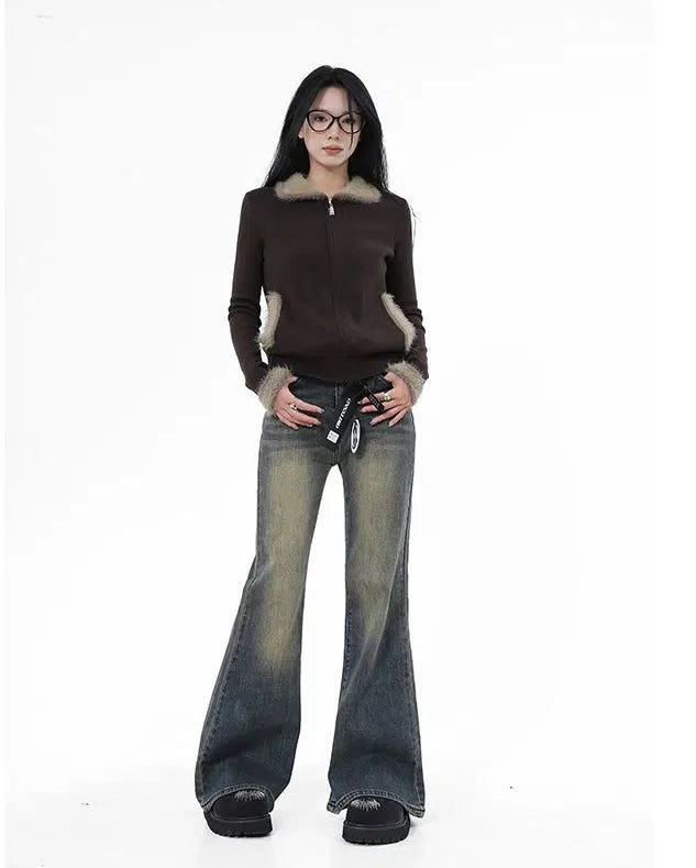 a woman in a brown sweater and jeans